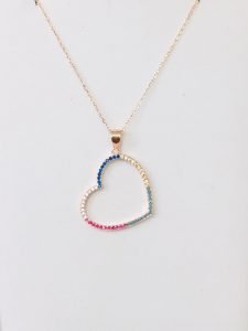 heart shaped necklace with a chain on the wall hanging on