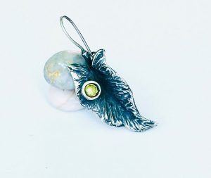 single leaf earring with a green lemon colored stone
