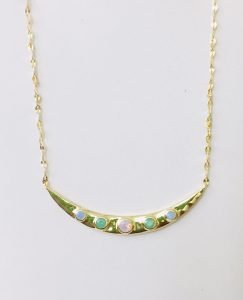 moon silver necklace with a chain hanging on