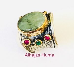 a brass ring with oval faceted smoke quartz