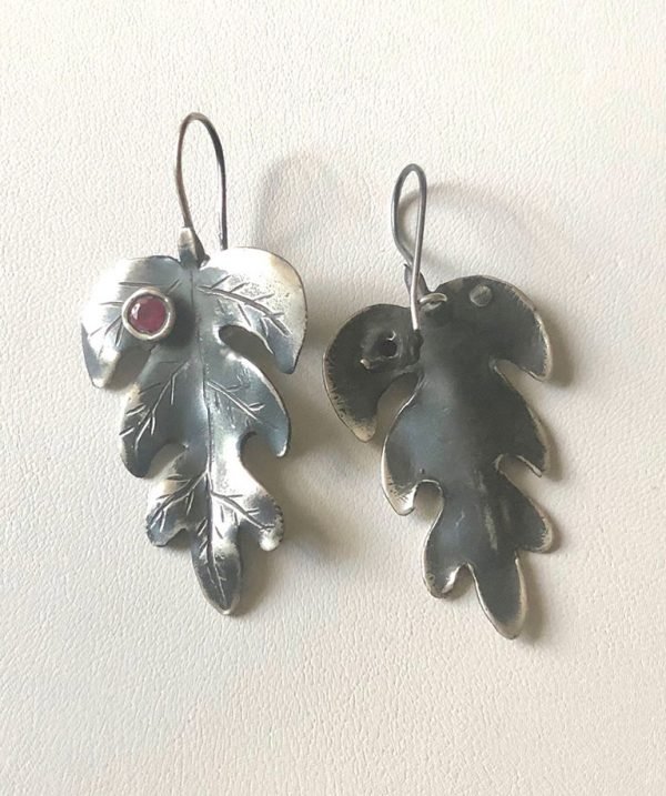 sterling silver earrings with small ruby stones on the wall