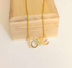 true love necklace gold color in front wood box