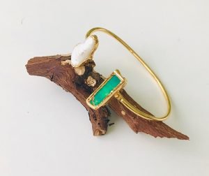 one bangle gold plated has an pearl and a green mojave