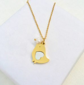 stainless steel pigeon necklace on the white stand displaying