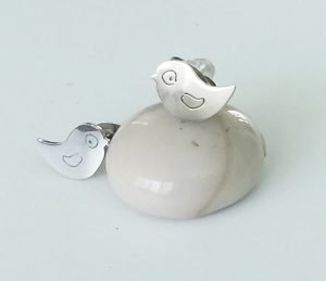 one bird figure on the bottom other bird figure on the top