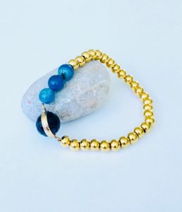 black stone bangle gold color white surface