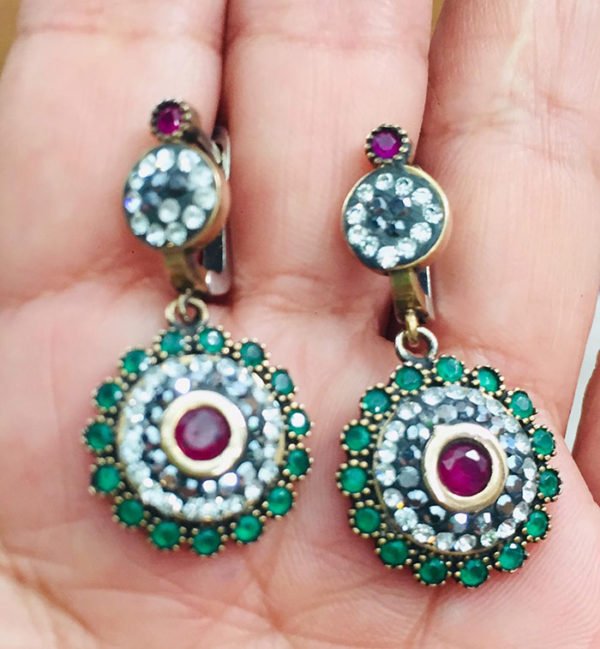 earrings in a woman's hand