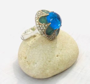 a big blue topaz stone with embeded small stones in the edges