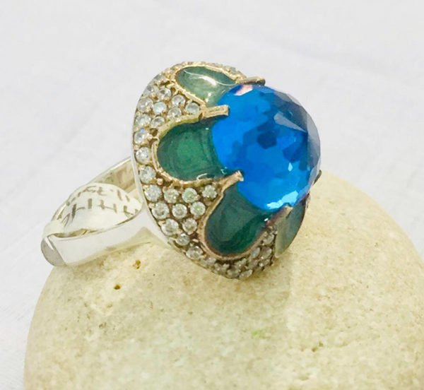 an original silver ring with blue topaz stone