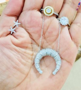 crystal horn necklace in a woman's hand