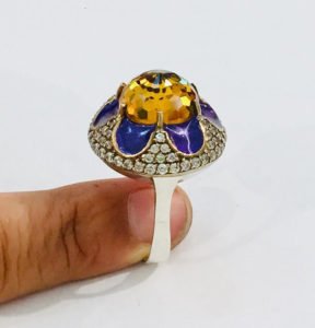 woman finger holding silver citrine ring