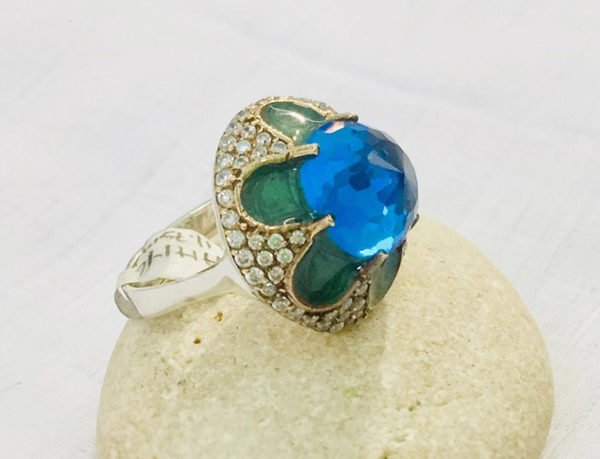 blue topaz ring on the stone with whited background