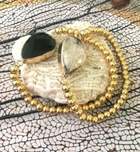 black and onix quarts stones bracelet are seen on white stone