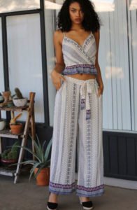 brown skin model in the front of door wearing wide leg pants