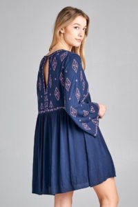 side view of young girl with navy blue mini dress