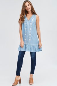 girl wearing short embroidered dress with sleeves