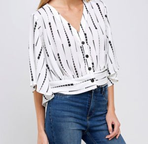 a white top in V neck with pattern