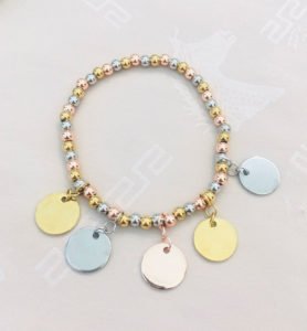 a three tone coin shape necklace displaying in white background