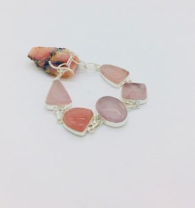 a rose quartz stone bracelet displaying
