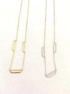 two trendy neckaces gold and silver colors displaying
