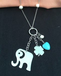 an elephant necklace in black color background