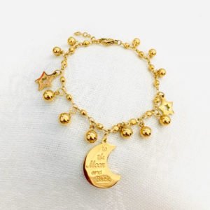 gold moon star bracelet is displayed in the gray background