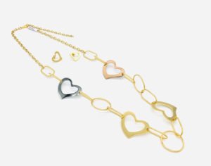 side view of a heart chain necklace in white displaying platform