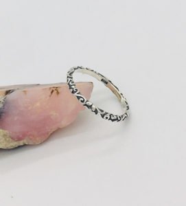 a trendy silver ring 925 on the edge of a stone