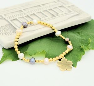 gold flower necklace with white grey pearls