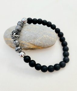 skull bracelet displaying on a stone