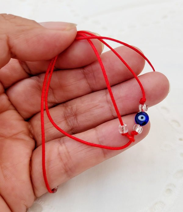 woman holding evil eye bracelet