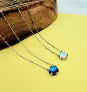 two pairs of aurora necklaces in white and blue colors