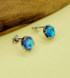 blue color aurora earrings on yellow surface