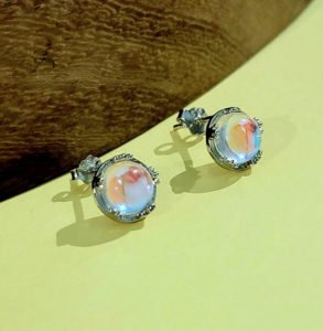 a pair of white aurora borealis earrings