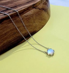 White-Aurora-Borealis-Necklace on Yellow Surface